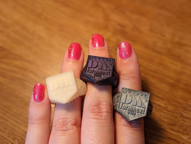 [3D printed rings in prototype polymer and final metal form from Desktop Metal&rsquo;s Formnext 2022 display &ndash; the latest event iteration from their collection // Image Source: Author]